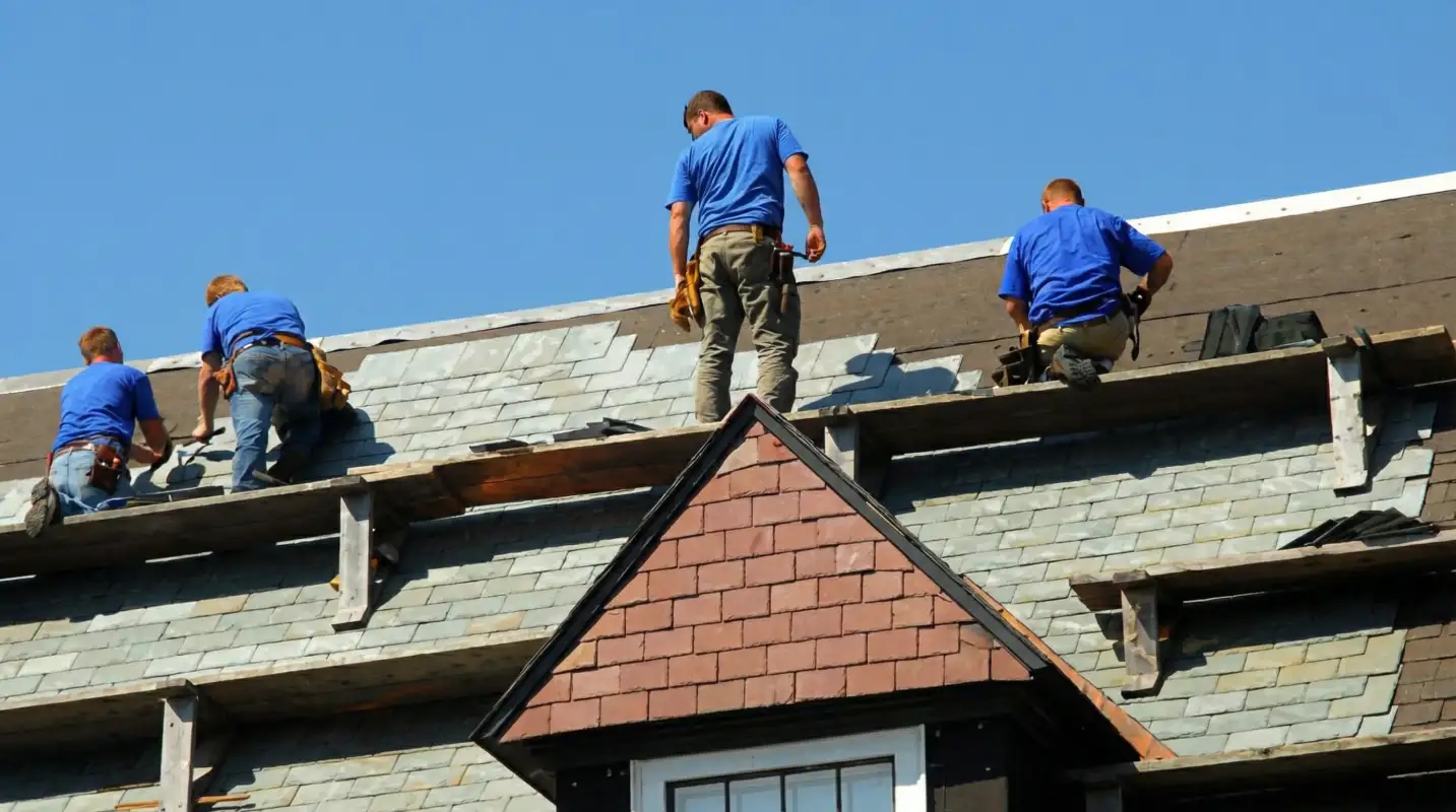 Roof replacement in progress with a team of professional contractors installing new shingles on a residential home in Jersey City, NJ