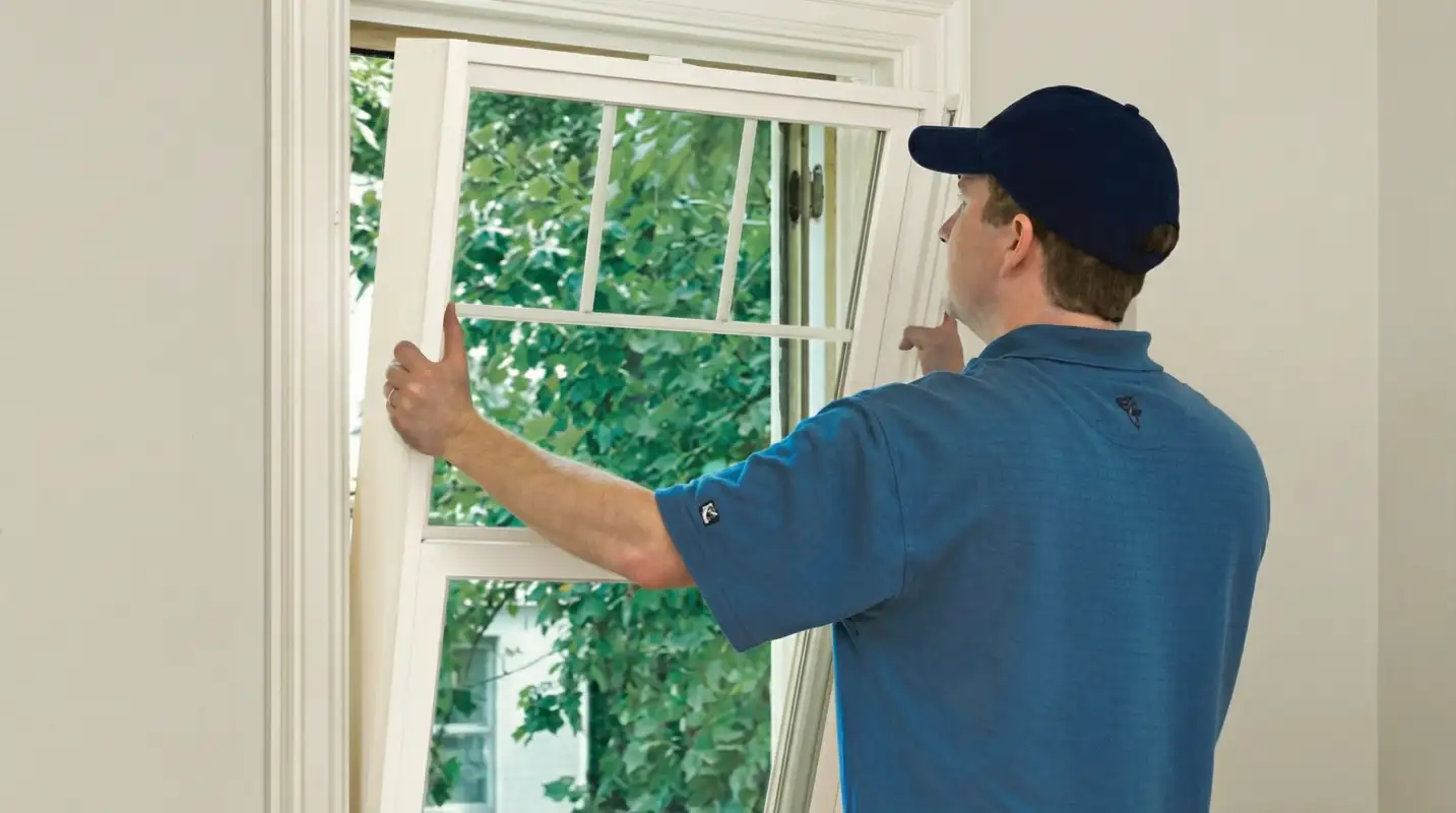 Professional contractors performing a residential window insulation and replacement service in Jersey City, NJ